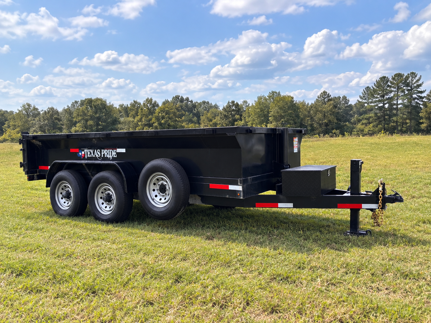 7'x14' Texas Pride dump trailer side view in a field