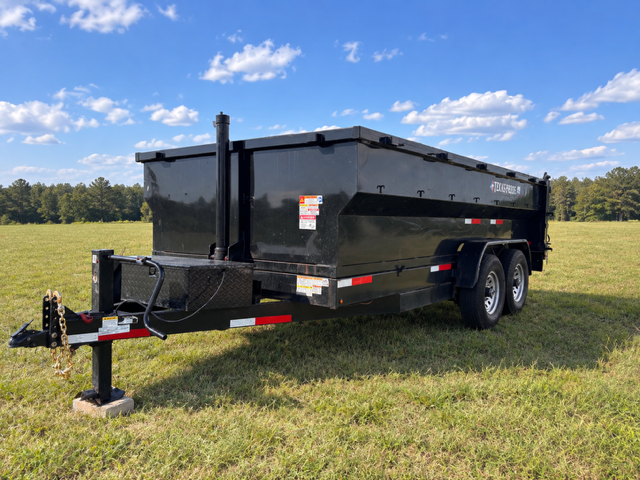 7'x16' Texas Pride dump trailer front angle view in a field